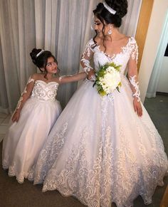 two women in wedding dresses standing next to each other