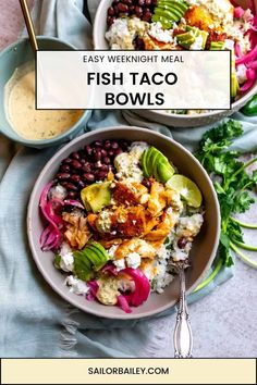 two bowls filled with fish taco bowls on top of a blue cloth next to silver spoons