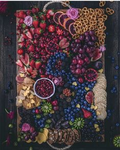 an assortment of fruits and pastries laid out on a board