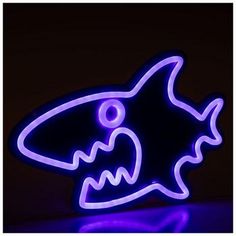 a blue neon sign with a fish on it's face in the shape of a shark