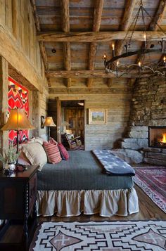 a bed sitting in a bedroom next to a fire place under a chandelier