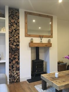 a living room filled with furniture and a fire place in front of a tv mounted on a wall