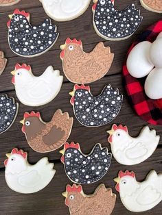 decorated cookies are arranged on a wooden table