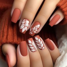 A matte burnt-orange base with white leaf stamping on one or two accent nails. The leaves are detailed and spread across the nail, giving a subtle nature-inspired look perfect for autumn. The matte finish adds a cozy, earthy feel to the design White And Burnt Orange Nails, Orange Matte Nails Design, Autumn Matte Nails, Nail Ideas For November, Leaf Stamping, November Nail Designs, Orange Nail Designs, Boho Nails, Simple Fall Nails