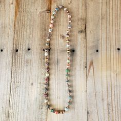 Own this handmade piece of jewelry - a Rainbow Multi-color Stripe (with gold accents) Recycled Paper Beads Necklace - which has been handcrafted by artisan women in Uganda. This strand is pre-strung. Bead Size: 7-12 x 13-25mm Strand Length: 23" Approximate # of Beads: 46 Hole Size: 1mm  MORE ETHNIC UGANDA ITEMS AVAILABLE  Browse our Etsy store for more ethnic jewelry and baskets. We are adding more items every day.  FREE SHIPPING  ---------------------------------------------- ABOUT THE BINJI MINISTRIES  We believe in equipping, teaching and empowering Ugandan widows, abandoned families and communities. This handmade product promotes fair trade. Production provides income opportunities for impoverished communities Uganda. Support of these handicrafts helps women provide an income for their Multicolor Spiritual Necklace For Everyday Wear, Multicolor Spiritual Necklace For Everyday, Spiritual Multicolor Necklaces For Everyday Wear, Spiritual Multicolor Necklace For Everyday, Multicolor Wooden Beads Necklace For Meditation, Earthy Multicolor Jewelry With Wooden Beads, Earthy Multicolor Wooden Beads Jewelry, Spiritual Multicolor Beaded Necklaces For Everyday, Spiritual Multicolor Beaded Necklace For Everyday