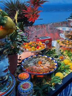 a table filled with lots of food on top of a blue and white table cloth