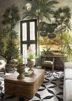 a living room with black and white flooring and palm trees painted on the walls