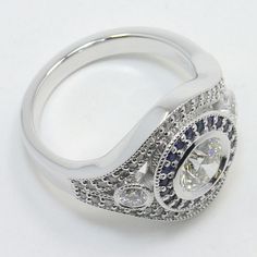 a diamond and blue sapphire ring on a white background