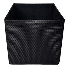 a black basket that is sitting on the ground