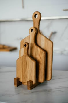 three wooden cutting boards sitting on top of a counter