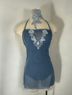 a mannequin wearing a blue top with flowers on it