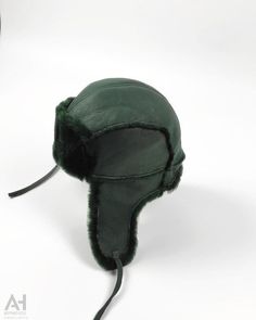 A classical and a very practical aviator-trapper hat can now accompany you in a daily basis . Proposed for men and women of every age. Very comfortable and easy to wear . An Aviator Napa Sheepskin hat with earflaps and leather strings . This great everyday hat is made of green napalan sheepskin , the outer part , and soft green sheepskin wool the inner and front part . It is very light and extremely durable to any conditions. It offers great comfort and natural warmth. A great in every aspect aviator hat to literally be your everyday companion in every single activity. Tough enough to endure every challenge. It keeps the head naturally warm and not sweaty since sheepskin is nature's greatest insulator. Product description: 100% handmade product Natural materials Genuine Sheepskin Base : gr Sheepskin Hat, Aviator Hat, Trapper Hat, Trapper Hats, Hat Fashion, Natural Materials, Dark Green, Caps Hats, Accessories Hats