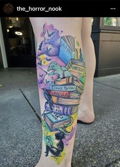 a woman's leg with books on it