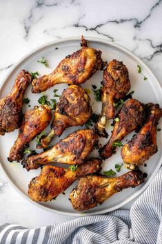 chicken wings on a white plate with parsley