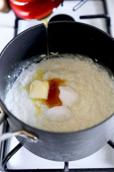 a pan filled with food sitting on top of a stove next to an orange and red pepper