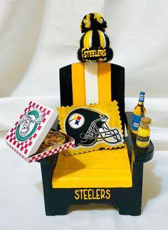 a football themed chair with beer and other sports related items sitting on top of it