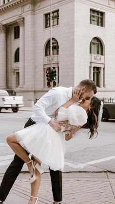 a man and woman kissing on the street