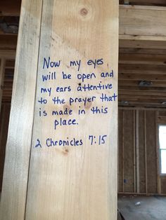 a piece of wood with writing on it in a room under construction that is being built