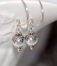 Sterling Silver Hoops and Swarovski Pearl Earrings Geogeous, Classic 8mm Petite Swarovski glass pearls adorned with antiqued silver beadcaps and little Swarovski crystals. All suspended from Handmade(by me) Sterling Silver hoops. Handmade Silver Pearl Bridal Earrings, Silver Round Pearl Earrings For Wedding, Silver Pearl Bridal Earrings For Mother Of The Bride, Silver Round Jewelry For Mother Of The Bride, Classic Beaded Wedding Earrings, Silver Jewelry For Mother Of The Bride, Handmade Silver Pearl Earrings For Wedding, Classic Round Bead Wedding Earrings, Silver Pearl Earrings With Round Beads