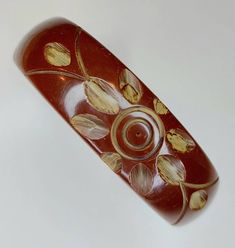 An iconic pattern in carved bakelite on this lovely chocolate brown. Brown Bakelite Bangle Bracelet, Vintage Carved Brown Bracelets, Vintage Brown Carved Bracelets, Brown Carved Bracelet Jewelry, Antique Brown Bracelet Gift, Brown Carved Bangle Bracelets, Antique Brown Bracelet Ideal For Gifts, Brown Bakelite Jewelry Gift, Brown Bakelite Jewelry As A Gift