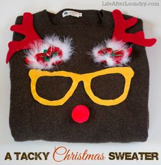 a ugly christmas sweater with reindeer glasses and red nose hair clippings on it