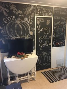 the chalkboard wall is decorated with pumpkins