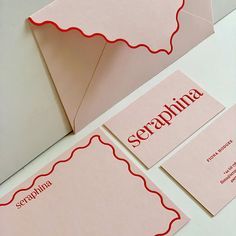 two pink envelopes with red scalloped border and the word scrappinna on them