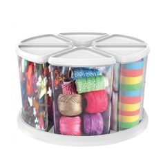 multicolored yarns and crochet hooks in plastic containers on a white background