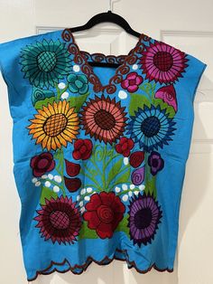 WOMEN'S HANDMADE EMBROIDERED MEXICAN BLOUSE MEDIUM SUNFLOWERS COLORFUL GORGEOUS BLOUSE COLOR TURQUOISE ARMPIT TO ARMPIT 20 INCHES NEW WITHOUT TAGS             SMOKE FREE AND PET FREE        I DO COMBINE SHIPPING :) SERIOUS BIDDERS ONLY PLEASE!!! PLEASE ASK ANY & ALL QUESTIONS BEFORE PLACING BID(S). PLEASE ASK IF IT IS NOT IN THE LISTING DESCRIPTION & IT IS IMPORTANT TO YOU. SALES ARE FINAL!!! SO ASK ANY & ALL QUESTIONS AHEAD OF TIME. I DO NOT ACCEPT RETURNS UNLESS ITEM HAS BEEN GROSSLY MISREPRESENTED.  PAYMENT IS DUE 3 DAYS AFTER AUCTION HAS ENDED. NON PAYING BIDDERS WILL BE REPORTED AND ITEM WILL BE RE-LISTED. I USUALLY SHIP ITEM WITH IN 1-2 DAYS. ***I SHIP ONLY WITHIN THE UNITED STATES*** ***I ONLY SHIP INTERNATIONAL THROUGH EBAY GLOBAL SHIPPING PROGRAM*** PLEASE BE PATIENT WITH USPS AS Mexican Blouse, Gorgeous Blouses, Color Turquoise, Dressy Outfits, Traditional Outfits, Sunflower, Auction, United States, Turquoise