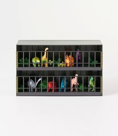 several toy animals are placed in a cage