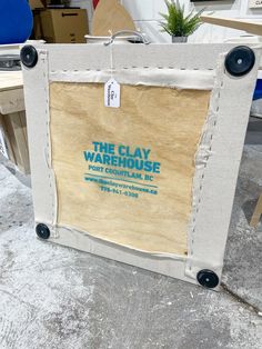 the clay warehouse sign has been taped to it's side and is on display