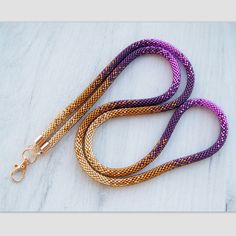 a purple and orange leash with gold clasps