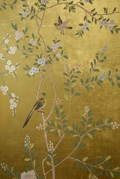 a gold wallpaper with birds and flowers on it