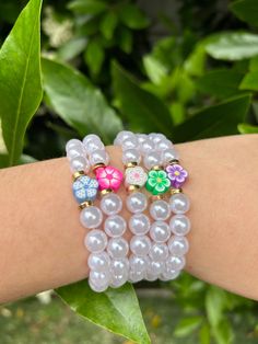 the bracelets are decorated with beads and flowers on each one arm, while the other is