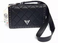 This exquisite Valentino Orlandi crossbody shoulder bag is a must-have for any fashion-forward woman. With its stunning diamond quilting and black exterior, it is sure to turn heads and make a statement. The bag features a turn-lock closure and gold-plated hardware, adding a touch of elegance to its already sophisticated design.  Measuring 9.5 inches in width, 5.5 inches in height, and 3 inches in depth, this medium-sized bag is perfect for any occasion, whether it be a casual outing or a formal event. With a detachable strap and lightweight design, it is also incredibly versatile and functional. This limited edition bag comes with a brand card and is sure to become a treasured addition to any collection. It can also be used as a Clutch with it's detachable Strap Black Valentino Crossbody Bag, Over Shoulder Bag, Valentino Crossbody, Limited Edition Bag, Medium Sized Bags, Crossbody Clutch, Black Exterior, Synthetic Materials, Black Quilt