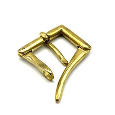 a gold plated metal clasp on a white background