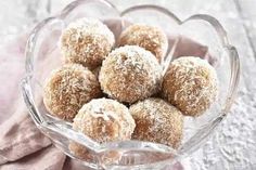 a glass bowl filled with sugar covered donuts