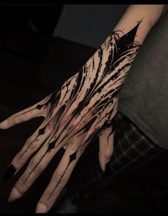 a person's hand with black and white ink on it, holding out their hands