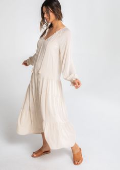 We all need that one dress that can check multiple boxes. This versatile bohemian style features a classic peasant dress silhouette, a relaxed fit, and delicate textured dot details throughout. Pair it with flat sandals for beach days, ankle boots, and a hat for date nights, or with statement heels for dinner parties. Featuring a flattering dropped waist, a flirty tiered skirt, and a pretty split v-neckline with tassel ties. Jacquard dot Relaxed fit Long raglan sleeves Ruffled wrist cuff Maxi le Sandals For Beach, Statement Heels, Bohemian Maxi, Lace Trim Cami, Bohemian Maxi Dress, Belted Shirt Dress, Peasant Dress, On Air, Ribbed Tank Tops