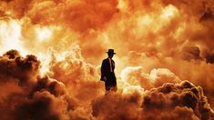 a man in a suit and hat standing on top of clouds