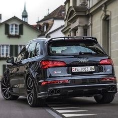 an audi car is parked on the street