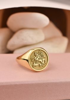 Welcome to LUXJ, Here you will find a beautiful selection of round signet rings with a variety of designs such as our saint George signet ring. Our team is happy to assist you with any questions you may have and we look forward to creating these special jewelry for you. *The images are taken from us and you will receive your ring as shown* | Information about the ring | - Face Size: 14x14mm - Band width at the bottom: 4mm | Material | - Sterling Silver 925 - Gold Vermail (925 base) - 9K Real Gol Signet Ring Gold, Saint George And The Dragon, Gold Pinky Ring, The Ring Face, Signet Rings, Saint George, Special Jewelry, Pinky Ring, Beautiful Gift Boxes