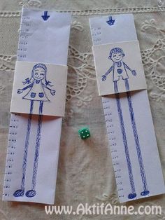 two sewing rulers with children's drawings on them, one green and the other white