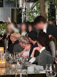 a group of people sitting around a dinner table