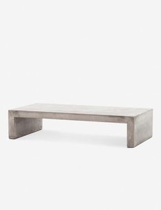 a concrete bench sitting on top of a white floor