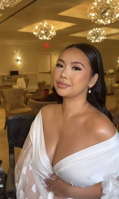 a woman in a white dress posing for the camera