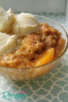 a glass bowl filled with fruit and ice cream