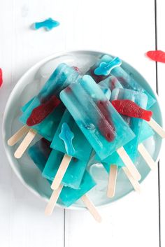 blue and red popsicles in a white bowl