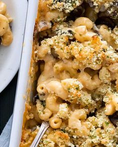 a casserole dish filled with macaroni and cheese, topped with mushrooms