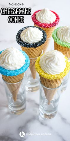 four ice cream cones with white frosting and colorful sprinkles on them